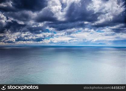 Overcast weather over sea, dark dramatic cloudy sky, dangerous seascape, panoramic landscape