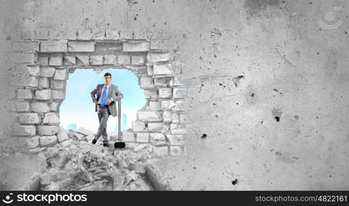 Overcoming challenges. Determined businessman with big hammer in hands