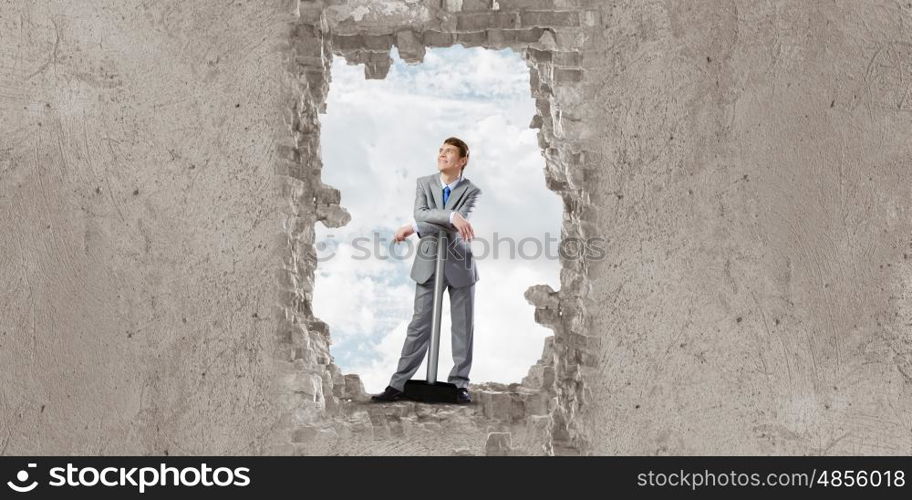 Overcoming challenges. Determined businessman with big hammer in hands