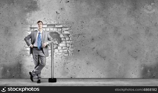 Overcoming challenges. Determined businessman with big hammer in hands
