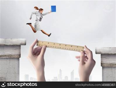 Overcoming difficulties. Businesswoman jumping over gap. Risk and challenge concept