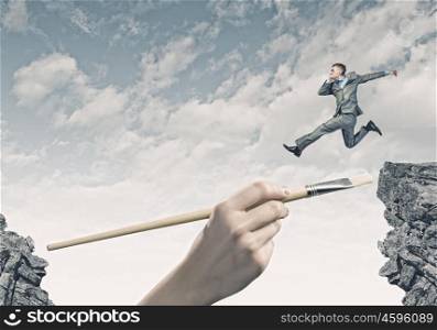 overcoming difficulties. Young successful businessman jumping over gap. Risk and challenge concept