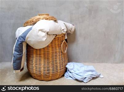 Overflowing wicker laundry basket. Household chore concept.