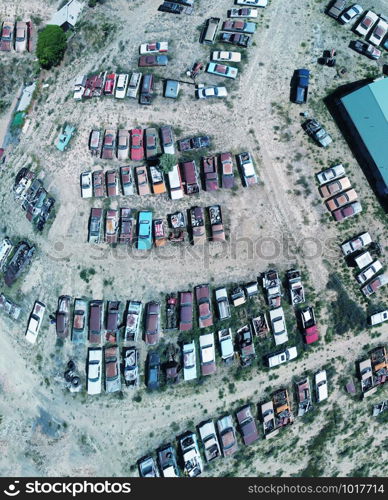 Overhead aerial view of cars wreckage gathered in a countryside parking.