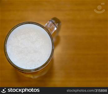 Overhead shot of beer in mug on table