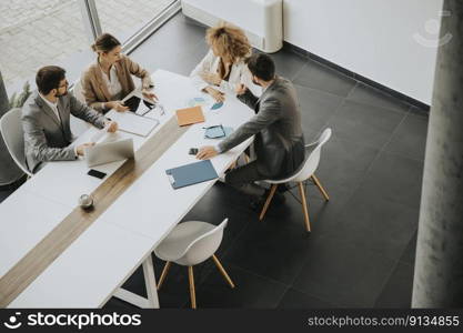 Overhead view at group of multiethnic business people working together in the office