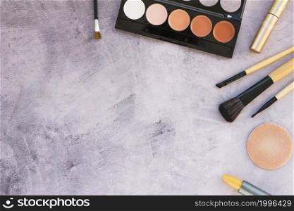 overhead view beauty products professional make up concrete background