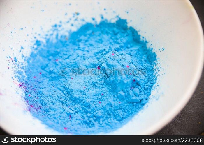 overhead view blue colored powder white bowl