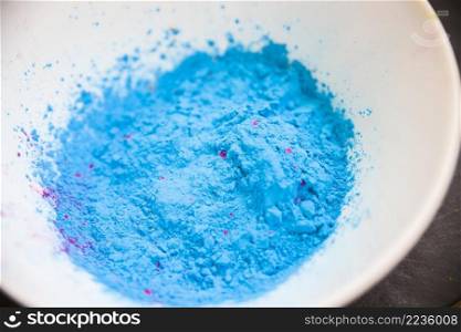 overhead view blue colored powder white bowl