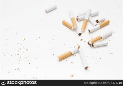 overhead view broken cigarette tobacco against white backdrop. High resolution photo. overhead view broken cigarette tobacco against white backdrop. High quality photo