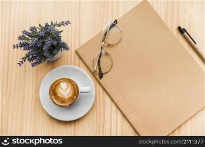 overhead view coffee latte stationeries lavender flower wooden background