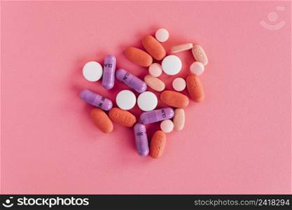 overhead view colorful pills pink background