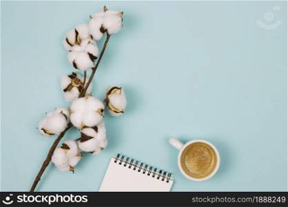 overhead view cotton flower spiral notepad coffee cup blue background . Resolution and high quality beautiful photo. overhead view cotton flower spiral notepad coffee cup blue background . High quality and resolution beautiful photo concept