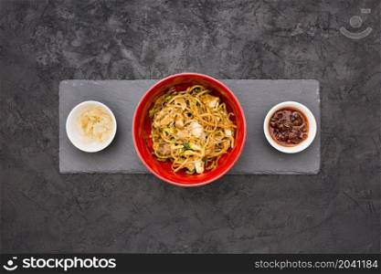 overhead view delicious noodles bowl with sauce marinated ginger black slate stone