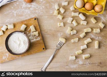 overhead view fork preparing fresh italian pasta gnocchi wooden desk