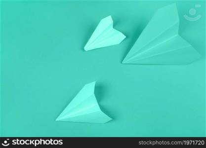 overhead view green paper airplanes mint background. High resolution photo. overhead view green paper airplanes mint background. High quality photo