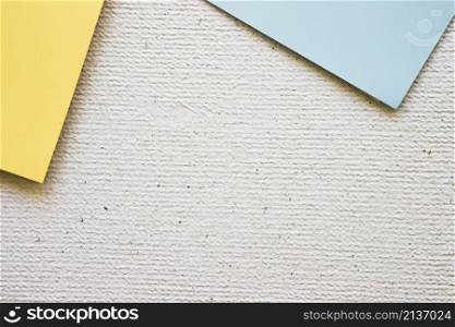 overhead view grey yellow cardboard papers concrete background