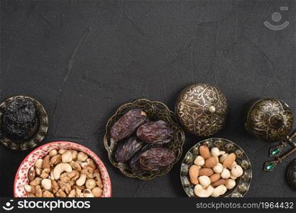 overhead view juicy delicious dates nuts metallic bowl concrete background. High resolution photo. overhead view juicy delicious dates nuts metallic bowl concrete background. High quality photo