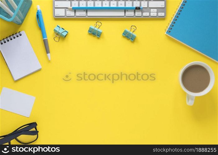 overhead view keyboard eyeglasses tea cup yellow workspace . Resolution and high quality beautiful photo. overhead view keyboard eyeglasses tea cup yellow workspace . High quality and resolution beautiful photo concept