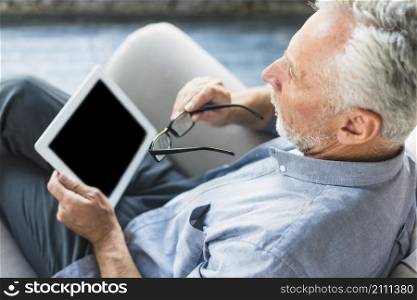 overhead view man holding digital tablet eyeglasses