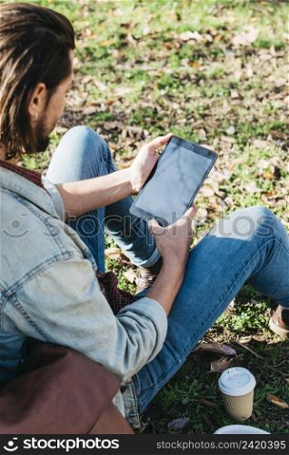 overhead view man sitting park using mobile phone