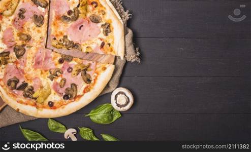 overhead view meat pizza with mushroom basil leaf wooden plank