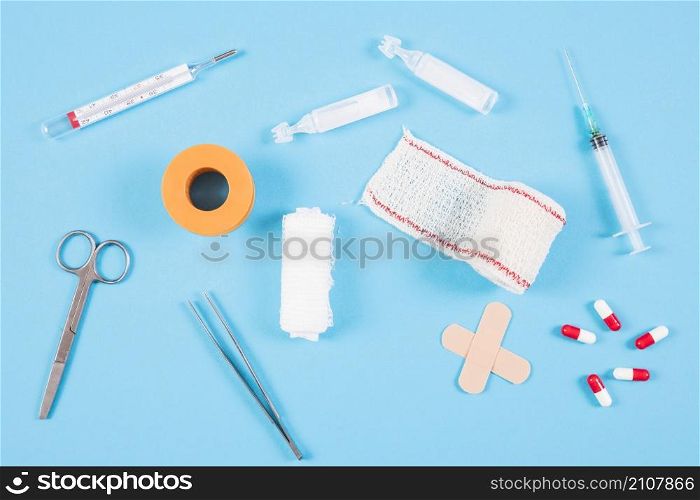 overhead view medical equipments blue backdrop