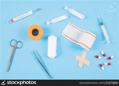overhead view medical equipments blue backdrop