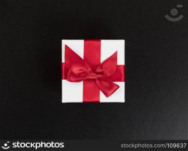 Overhead view of a gift box on dark stone background