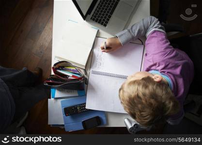 Overhead View Of Boy Studying In Bedroom