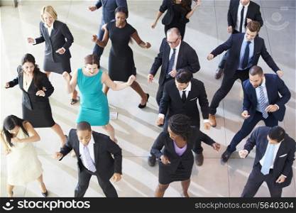 Overhead View Of Businesspeople Dancing In Office Lobby