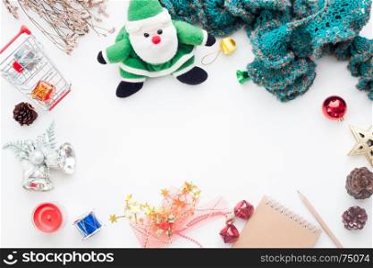 Overhead view of Christmas decorations, gift boxes and shopping cart on white background