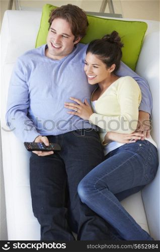 Overhead View Of Couple Watching TV On Sofa