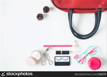 Overhead view of essential beauty items, Top view of red hand bag, fashion eyeglasses and cosmetics, top view isolated on white background