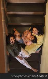 Overhead view of family members sitting on stairs at home