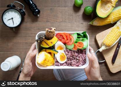 Overhead view of healthy lunch box with rice berry, boiled eggs . Overhead view of healthy lunch box with rice berry, boiled eggs and vegetables, preparing nutrition food, Healthy kitchen