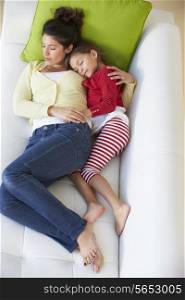 Overhead View Of Mother And Daughter Relaxing On Sofa
