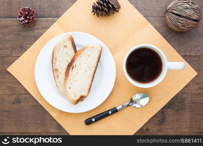 Overhead view of sliced homemade bread with coffee on table