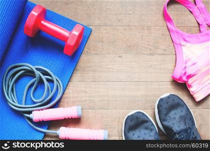 Overhead view of sport equipments on wooden background
