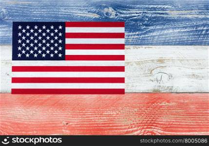 Overhead view of United States of America flag on wooden planks painted in national colors of red, white, blue. Patriotic concept.