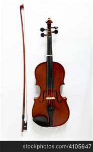 overhead view of viola and bow on white background
