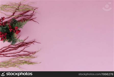 Overhead view of with warm gold and red flame decorations on a light pink setting for a Merry Christmas or Happy New Year background