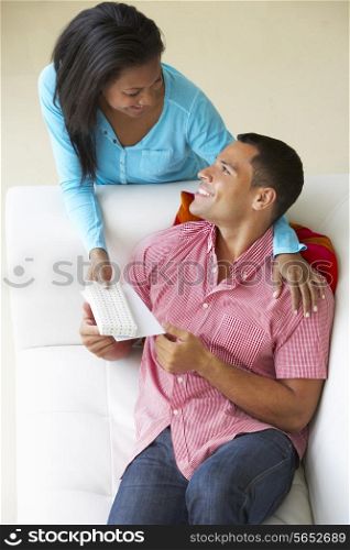 Overhead View Of Woman Giving Man Gift