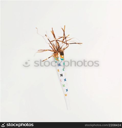 overhead view party popper with golden serpentine isolated white background
