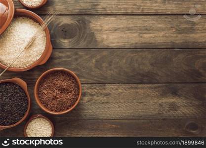 overhead view red brown white rice bowls wooden background. Resolution and high quality beautiful photo. overhead view red brown white rice bowls wooden background. High quality beautiful photo concept