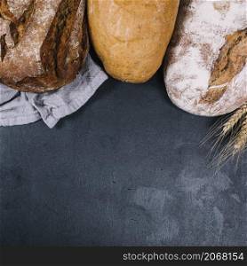 overhead view rustic loaf breads black counter top
