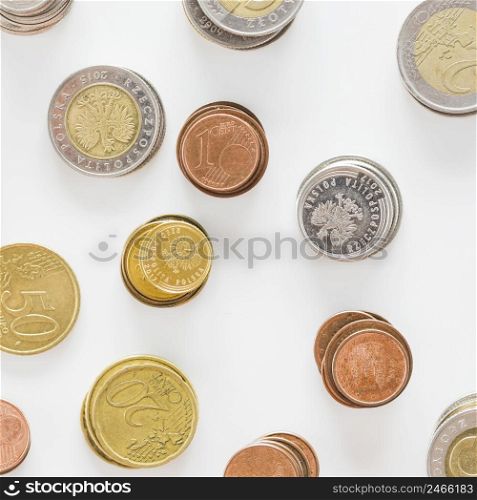overhead view silver gold copper coins white background