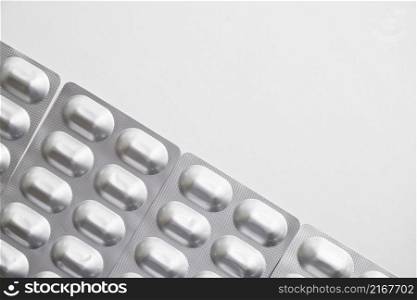 overhead view silver pills blister pack white background
