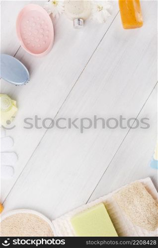 overhead view sponge herbal soap napkin gloves massage brush loofah flower wooden plank with space writing text