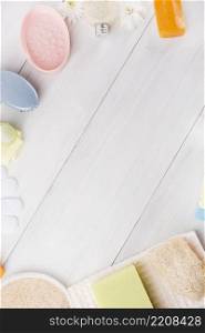 overhead view sponge herbal soap napkin gloves massage brush loofah flower wooden plank with space writing text